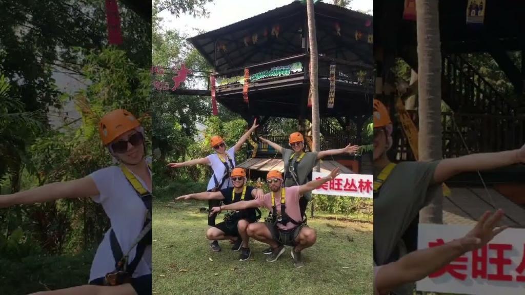 A group of people wearing safety gear, ziplining in Chiang Mai.